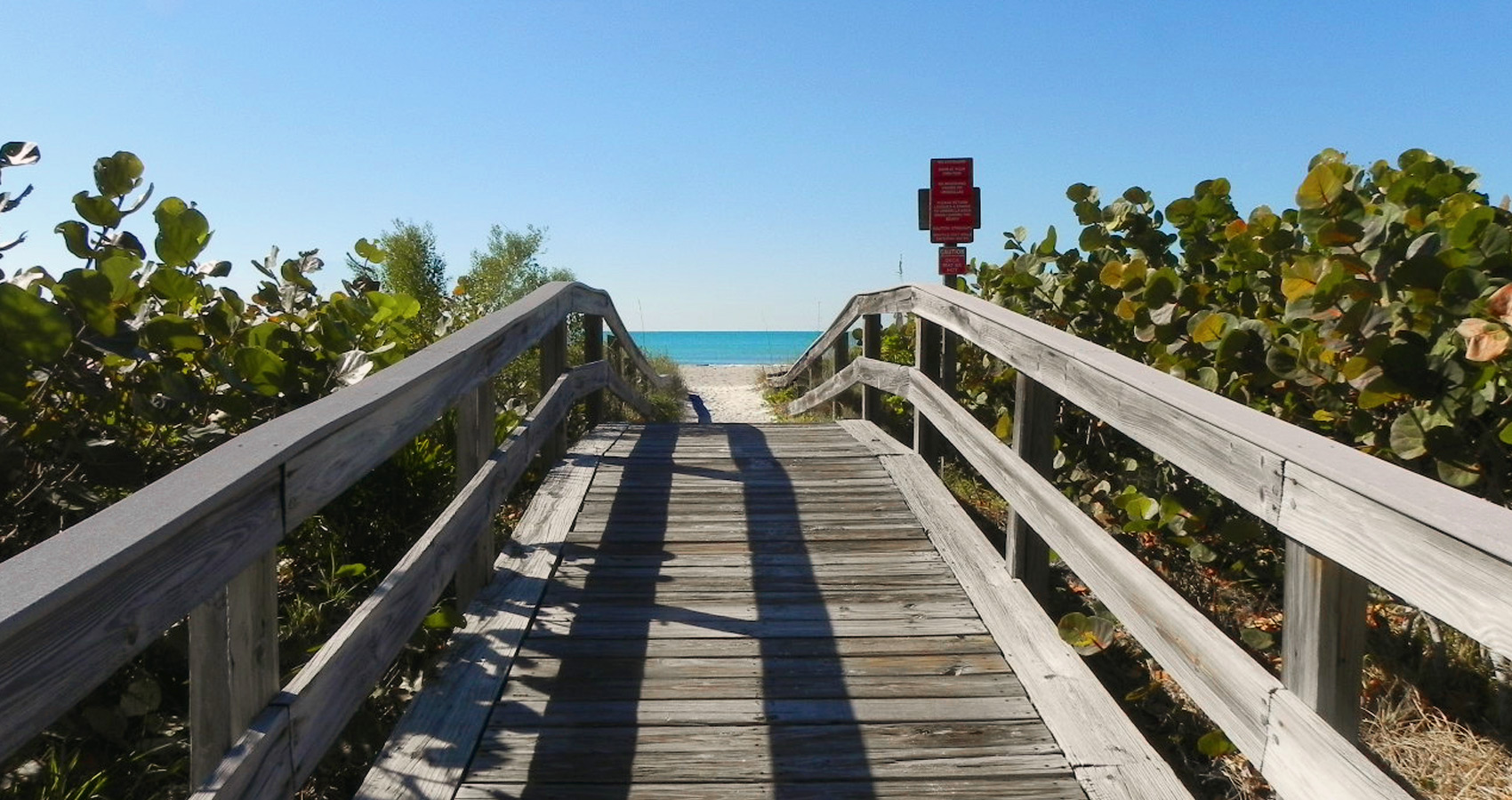 A wooden footbridge leading to the beach
